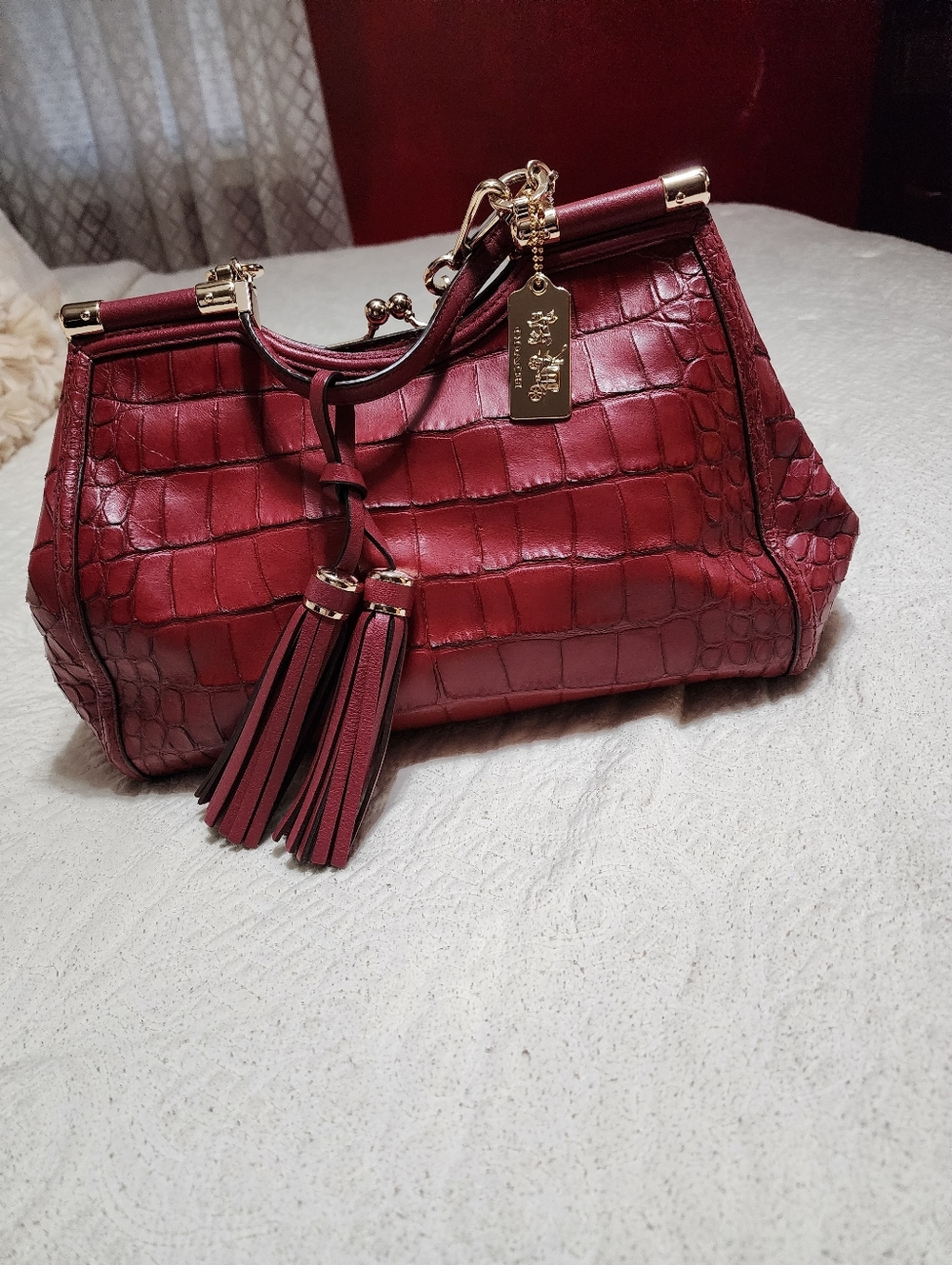 Coach Maroon croc-embossed satchel with a removable shoulder strap